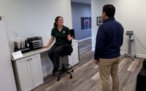 A staff member at our front desk talks with a visitor.